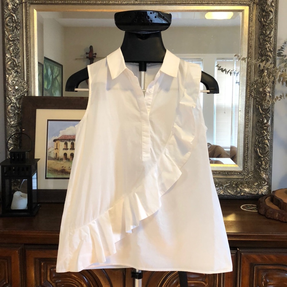 Small white sleeveless collared shirt with ruffle